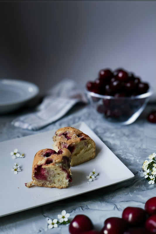 Cherry Clafoutis with Jaca dusted with powdered sugar, fresh cherries alongside